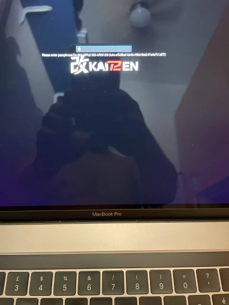 MacBook Pro showing the KAIT2EN LUKS passphrase prompt while its internal keyboard is unavailable